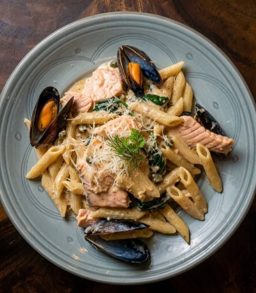 penne pasta with salmon and mussels in creamy sauce