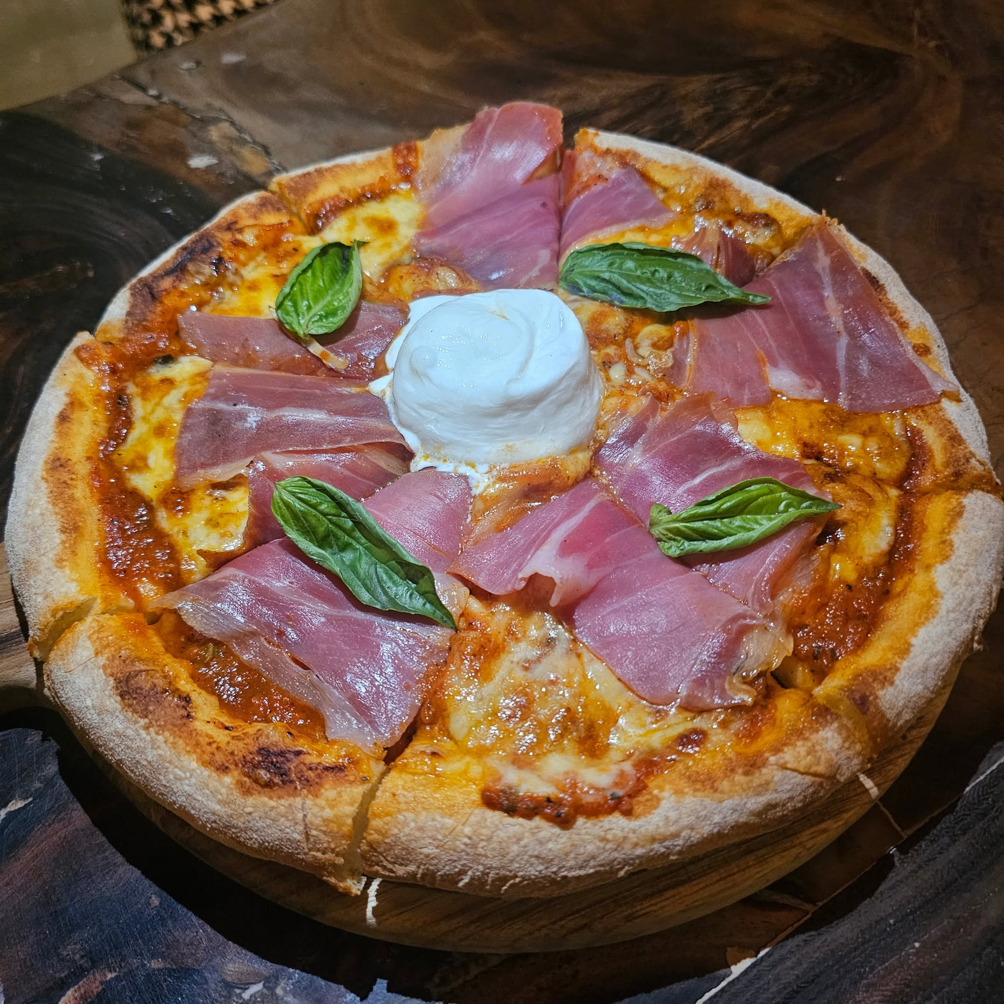 pizza with ham, basil, burrata